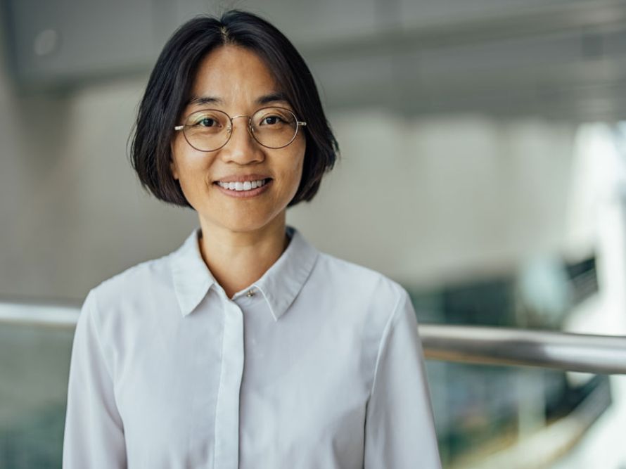 Woman in white button up smiling